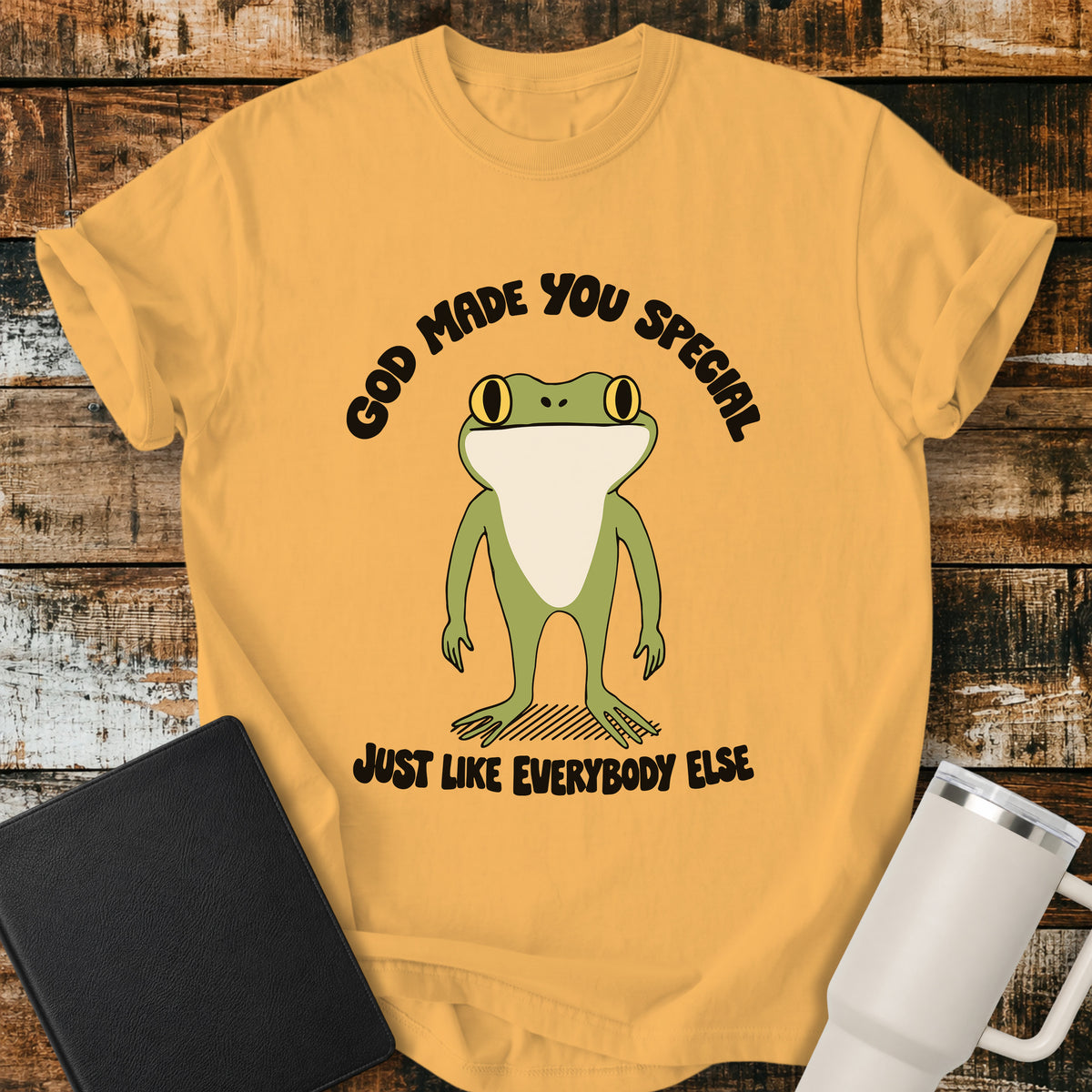 citrus yellow Christian T-shirt featuring a retro frog with the words “God Made You Special Just Like Everybody Else” in black lettering.