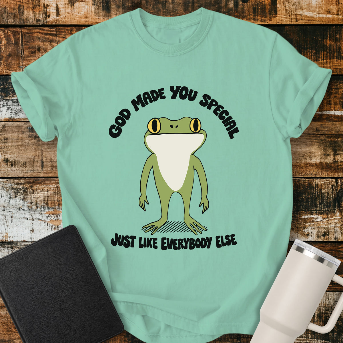 island reef green Christian T-shirt featuring a retro frog with the words “God Made You Special Just Like Everybody Else” in black lettering.