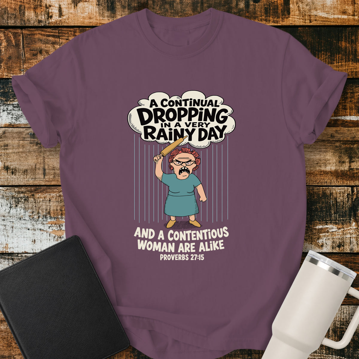 Berry Christian t-shirt featuring a humorous illustration inspired by Proverbs 27:15, with the verse “A continual dropping in a very rainy day and a contentious woman are alike.”