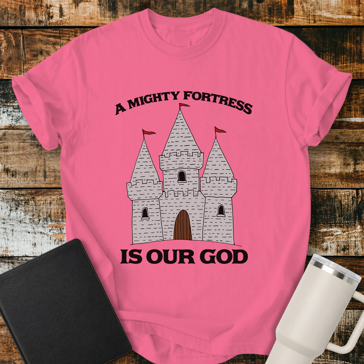 crunchberry Christian t-shirt featuring a hand-drawn castle illustration with bold vintage lettering reading “A Mighty Fortress Is Our God.”