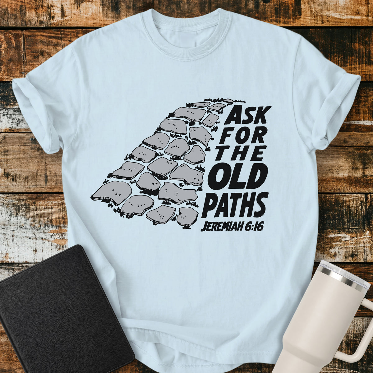 chambray blue Christian t-shirt featuring a vintage stone pathway illustration with bold retro lettering reading “Ask for the Old Paths” and Jeremiah 6:16.
