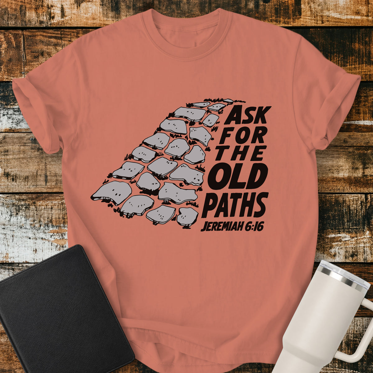Terracotta Christian t-shirt featuring a vintage stone pathway illustration with bold retro lettering reading “Ask for the Old Paths” and Jeremiah 6:16.