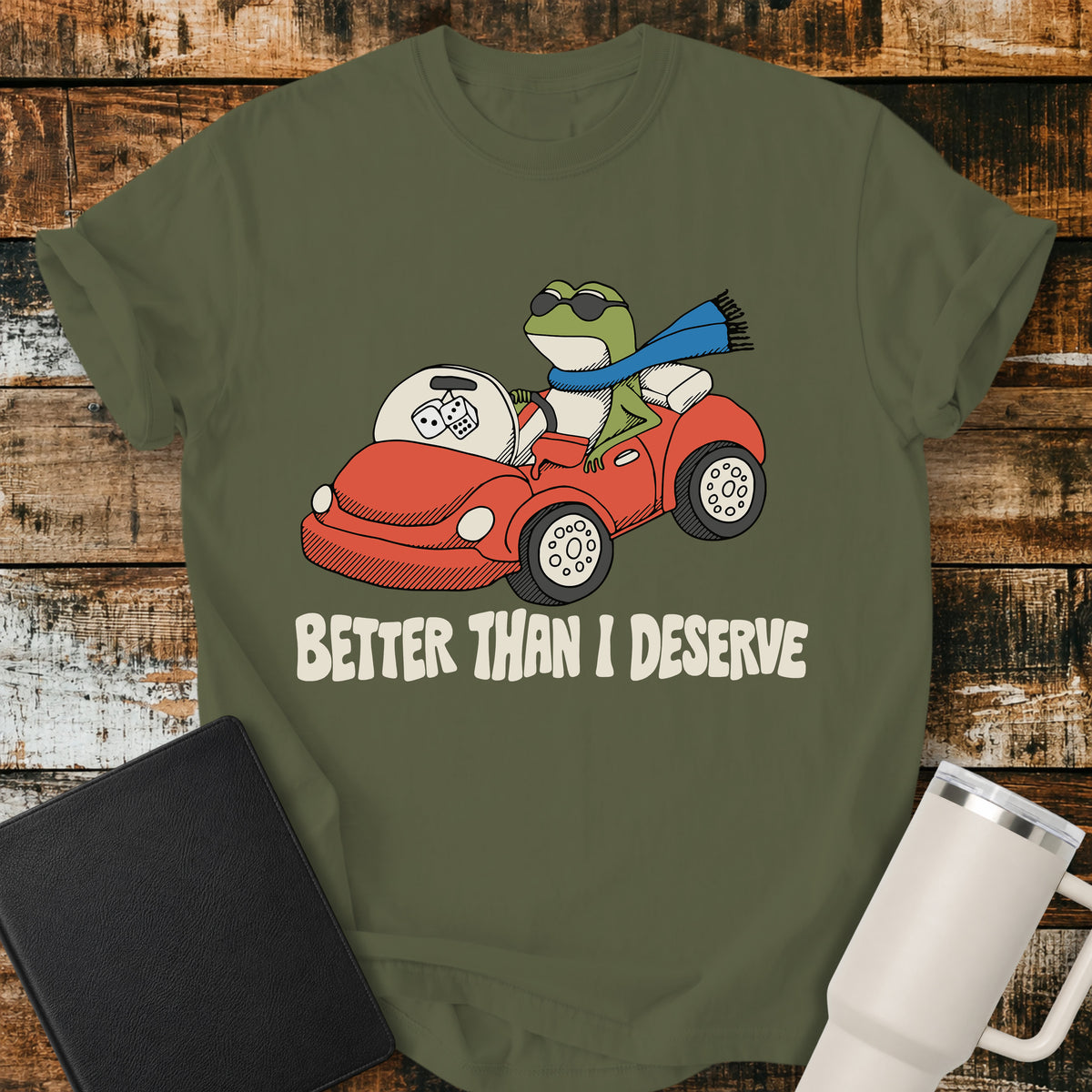 hemp green Christian T-shirt featuring a frog driving a red convertible with the words “Better Than I Deserve” in cream retro lettering.