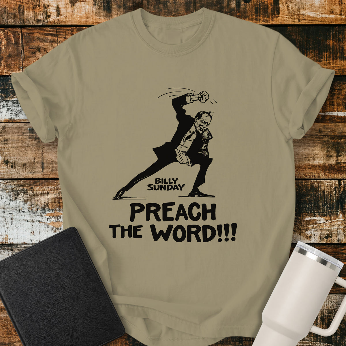 Khaki Christian T-shirt featuring a vintage-style illustration of evangelist Billy Sunday in an energetic preaching pose, paired with the bold message “PREACH THE WORD!!!” for a striking faith-based design.