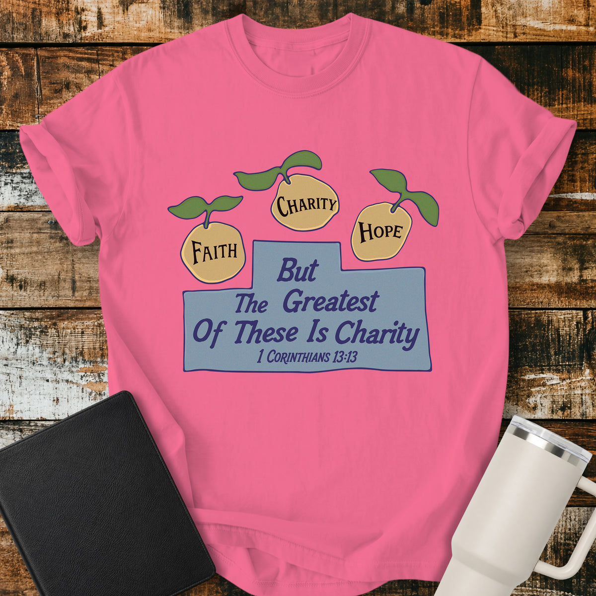 crunchberry pink Christian t-shirt featuring three lemons labeled “Faith,” “Charity,” and “Hope,” with the words “But the Greatest of These Is Charity” and 1 Corinthians 13:13. A cheerful, vintage-inspired biblical design illustrating faith, hope, and charity.