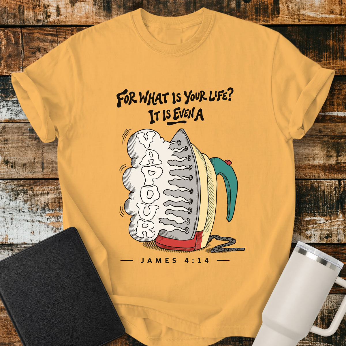 citrus yellow flat-lay t-shirt mockup featuring a colorful vintage-style steam iron releasing a large cloud of steam shaped into the word "VAPOUR." Above the illustration, stylized lettering reads, "FOR WHAT IS YOUR LIFE? IT IS EVEN A," with the Bible reference "JAMES 4:14" below. The faith-inspired design is displayed on a rustic wood plank background alongside a black leather Bible and a white insulated travel mug.