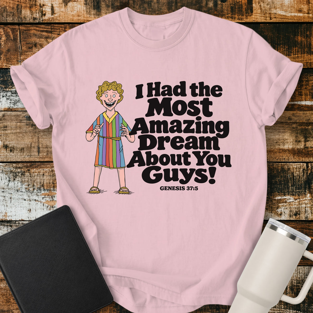 blossom pink Christian T-shirt featuring Joseph in a colorful coat with the humorous phrase “I Had the Most Amazing Dream About You Guys!” and “Genesis 37:5” in black lettering.