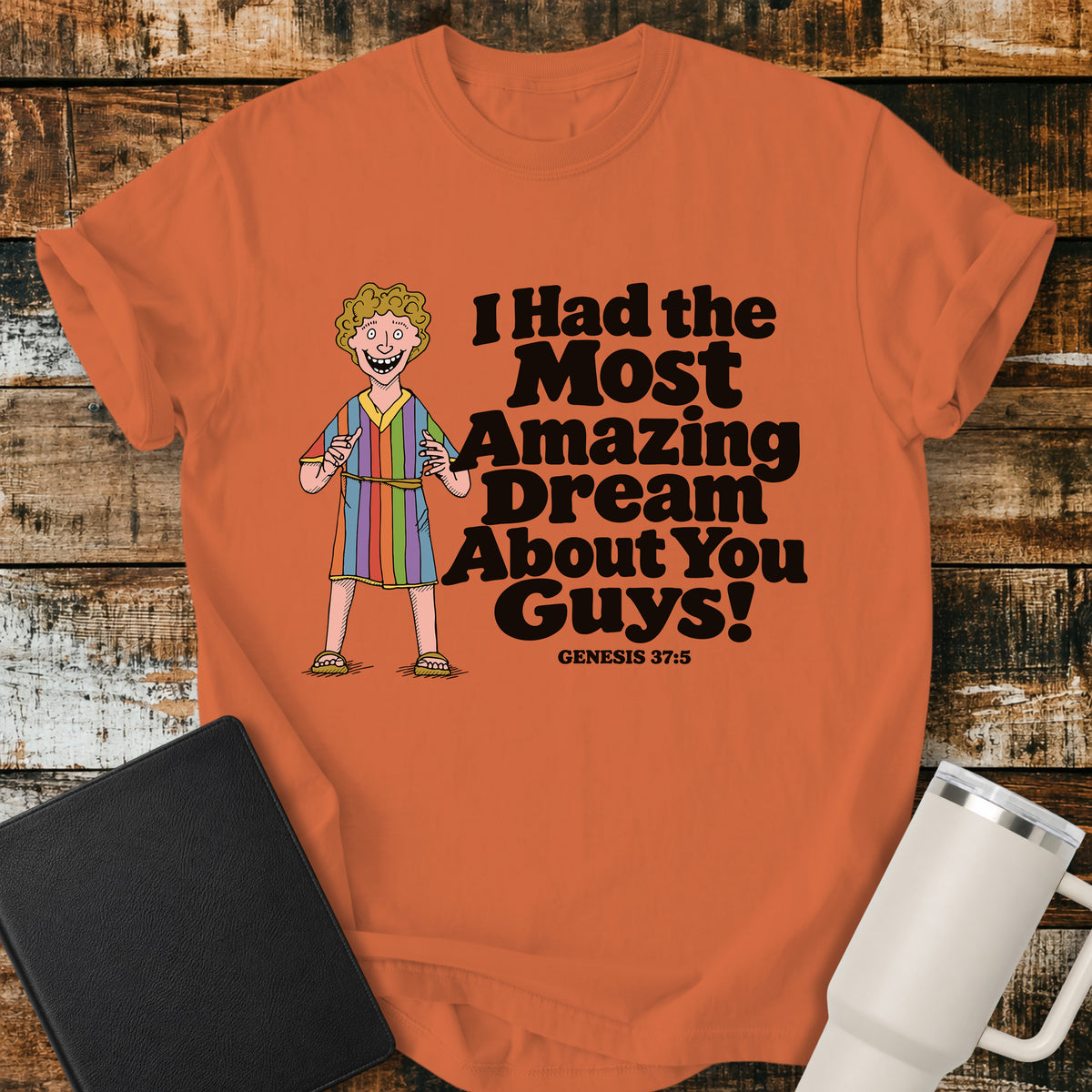 burnt orange Christian T-shirt featuring Joseph in a colorful coat with the humorous phrase “I Had the Most Amazing Dream About You Guys!” and “Genesis 37:5” in black lettering.