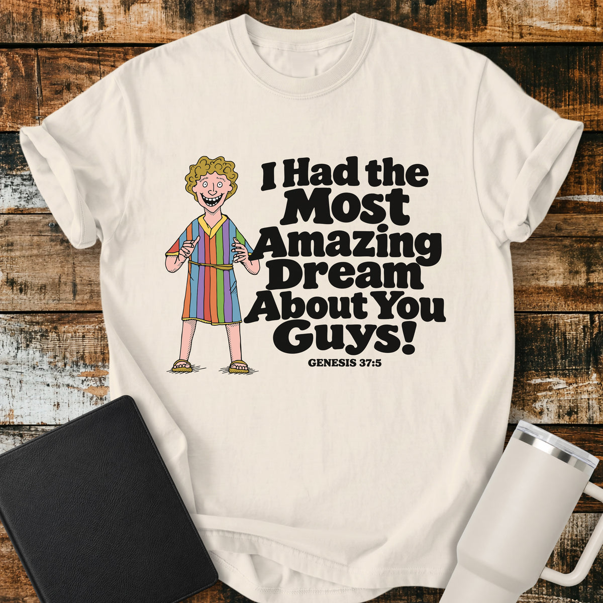 ivory Christian T-shirt featuring Joseph in a colorful coat with the humorous phrase “I Had the Most Amazing Dream About You Guys!” and “Genesis 37:5” in black lettering.