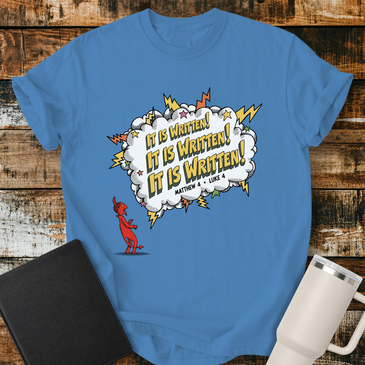 royal caribe blue Christian t-shirt featuring a comic-book-style burst with the words “It Is Written!” repeated three times, alongside a defeated devil character and references to Matthew 4 and Luke 4. A bold, playful biblical design inspired by Jesus answering Satan’s temptations with Scripture.