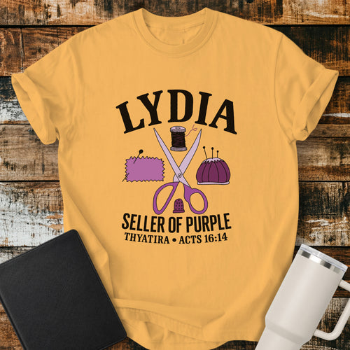 citrus yellow Christian t-shirt featuring vintage sewing illustrations including scissors, thread, fabric, pincushion, and thimble, with bold lettering reading “Lydia — Seller of Purple” and “Thyatira • Acts 16:14.”