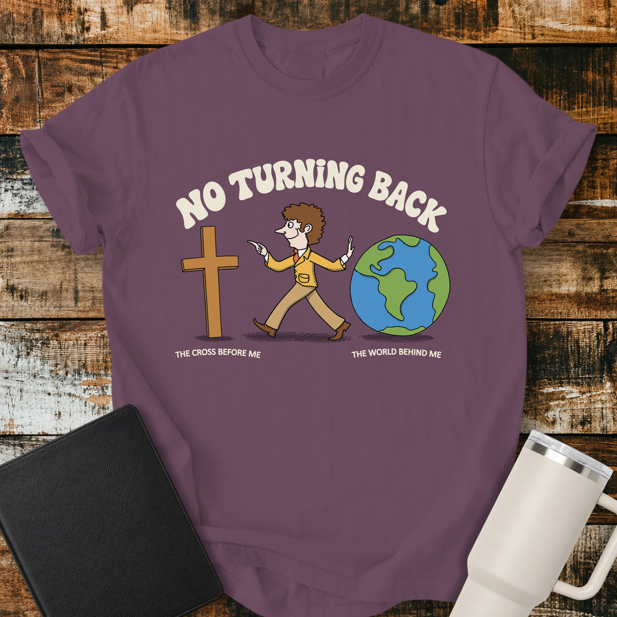 grape purple Christian t-shirt featuring a retro illustration of a man walking toward the cross and leaving the world behind, with the message “No Turning Back” and the phrases “The Cross Before Me” and “The World Behind Me.”
