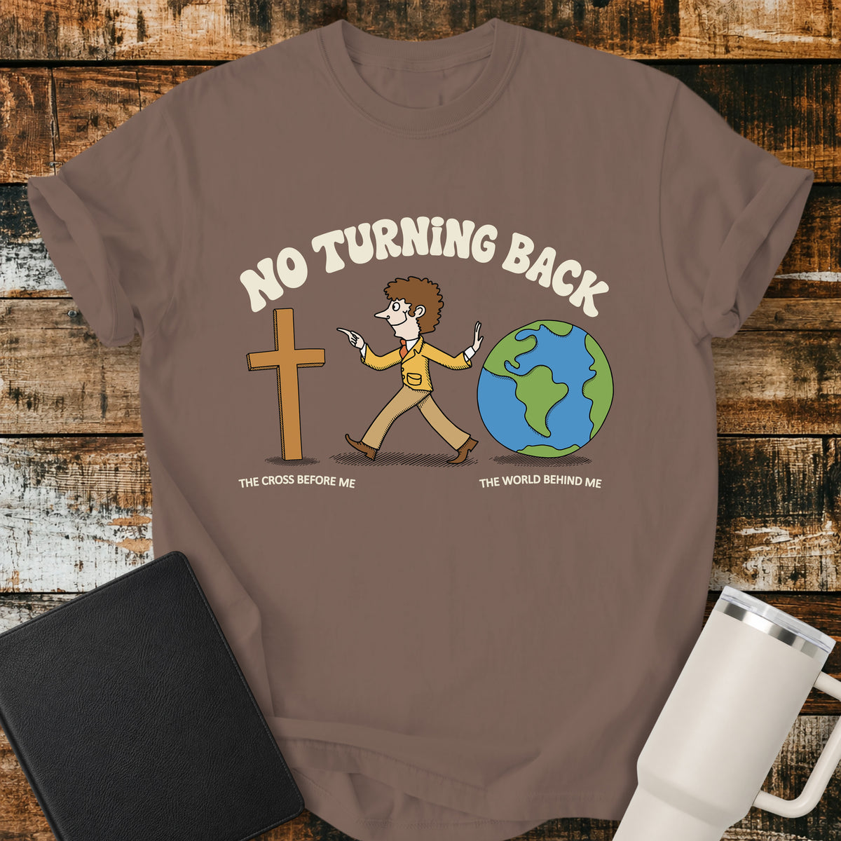 espresso brown Christian t-shirt featuring a retro illustration of a man walking toward the cross and leaving the world behind, with the message “No Turning Back” and the phrases “The Cross Before Me” and “The World Behind Me.”