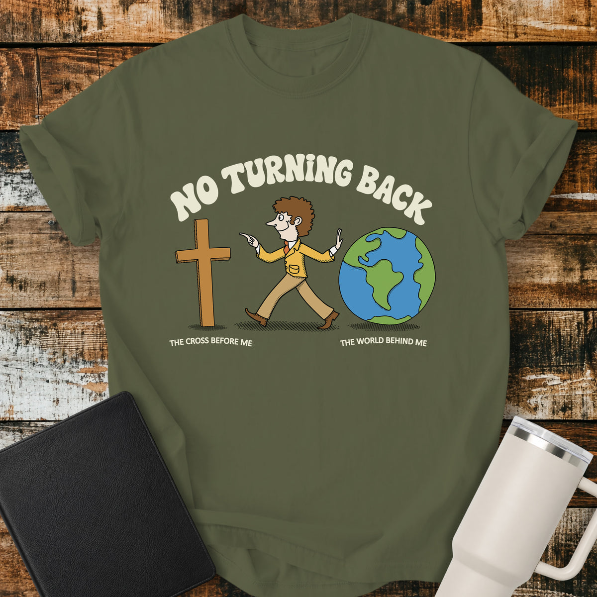 hemp green Christian t-shirt featuring a retro illustration of a man walking toward the cross and leaving the world behind, with the message “No Turning Back” and the phrases “The Cross Before Me” and “The World Behind Me.”