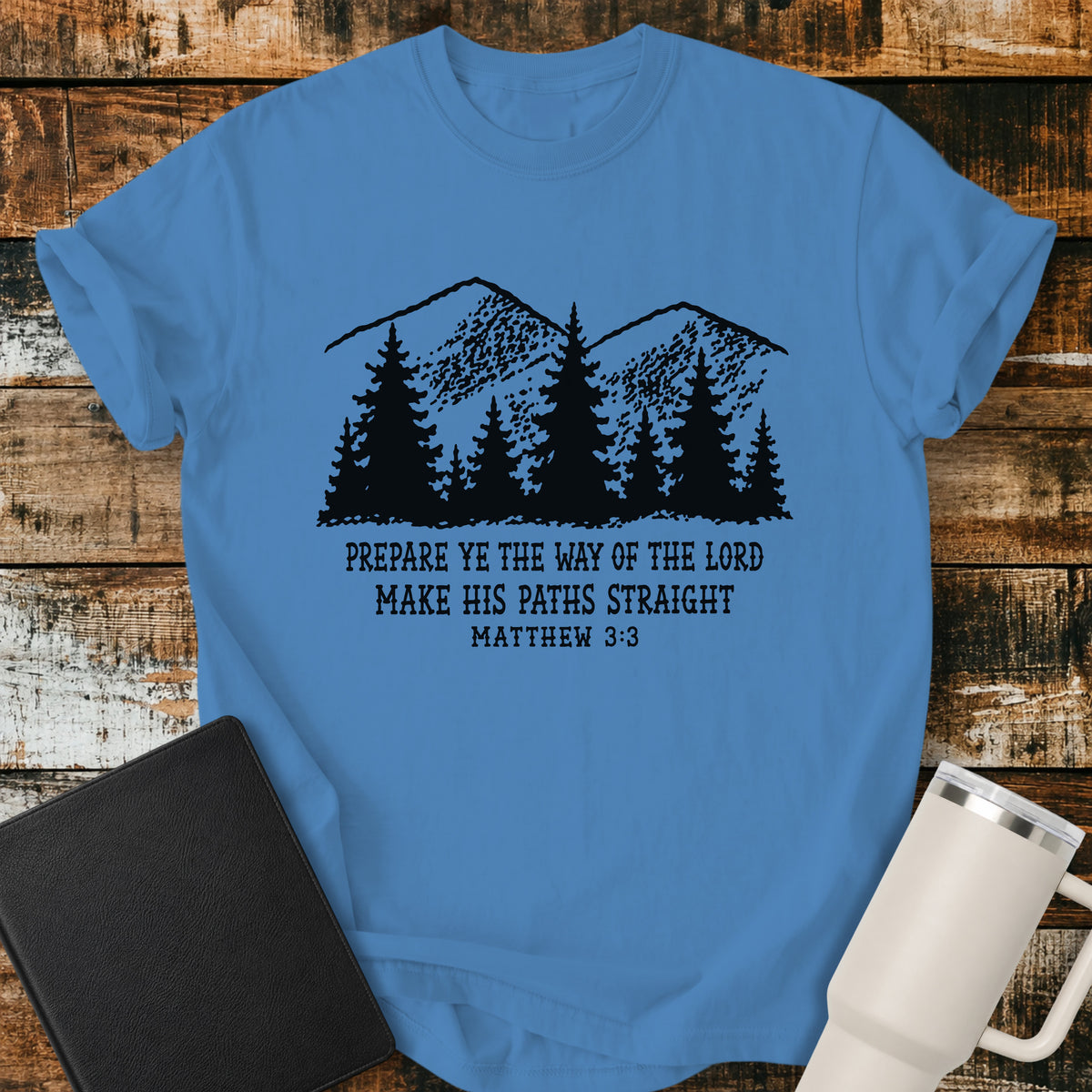 royal caribe blue Christian t-shirt featuring a vintage mountain and pine forest illustration with the words “Prepare Ye the Way of the Lord, Make His Paths Straight” and Matthew 3:3. A rugged, outdoors-inspired biblical design with classic black typography.