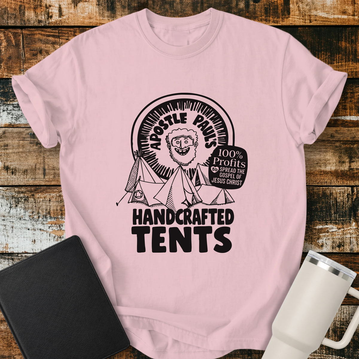 blossom pink Christian T-shirt featuring Apostle Paul with handcrafted tents and the words “100% Profits to Spread the Gospel of Jesus Christ.”