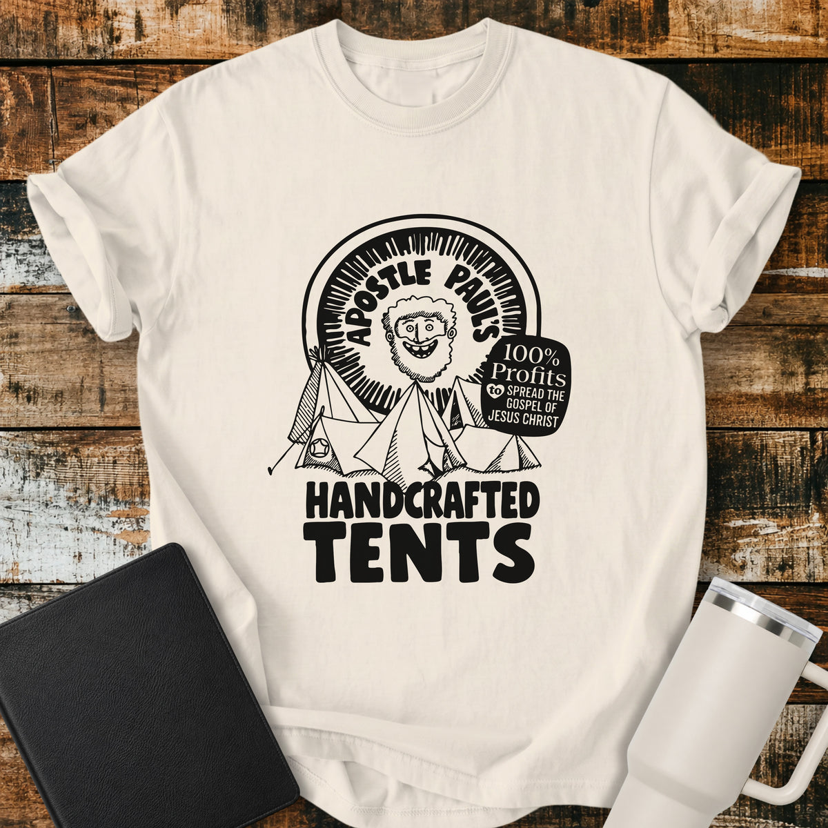 ivory Christian T-shirt featuring Apostle Paul with handcrafted tents and the words “100% Profits to Spread the Gospel of Jesus Christ.”