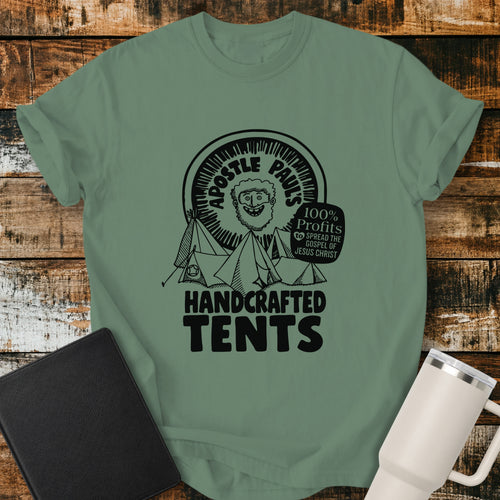 light green Christian T-shirt featuring Apostle Paul with handcrafted tents and the words “100% Profits to Spread the Gospel of Jesus Christ.”