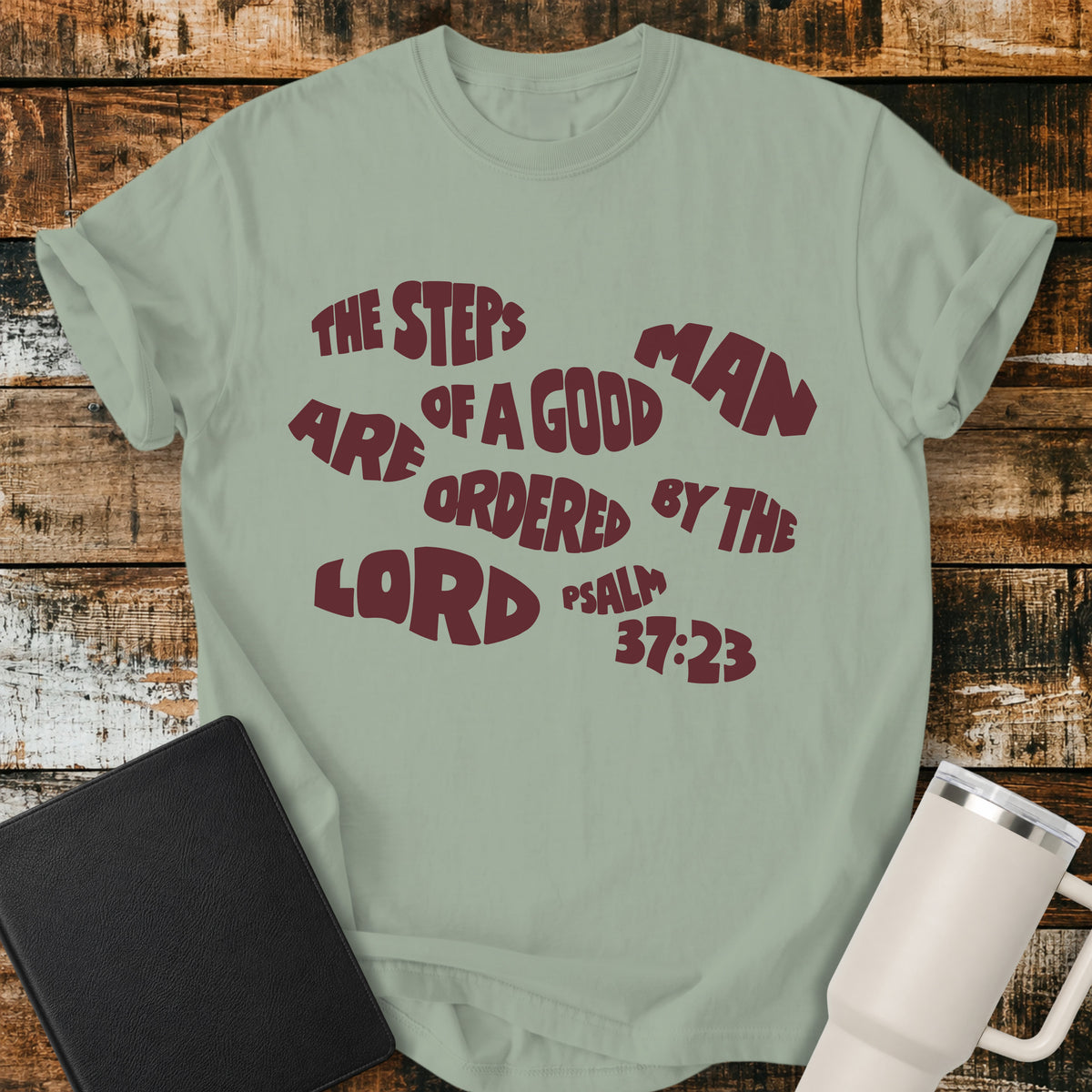 bay green Christian t-shirt featuring bold retro typography with Psalm 37:23: “The steps of a good man are ordered by the LORD.”