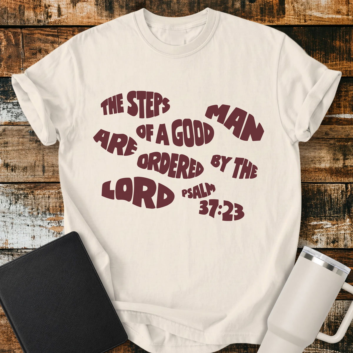 ivory Christian t-shirt featuring bold retro typography with Psalm 37:23: “The steps of a good man are ordered by the LORD.”