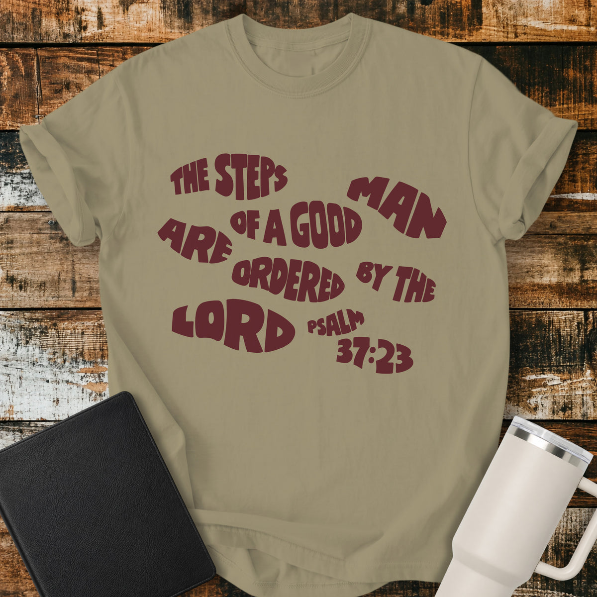 khaki Christian t-shirt featuring bold retro typography with Psalm 37:23: “The steps of a good man are ordered by the LORD.”